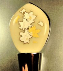 Wine or bottle stopper with gold and silver foil accents.