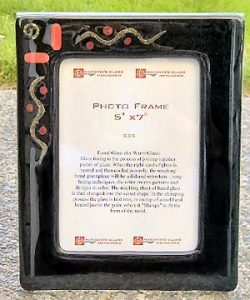 Red glass and brass accent this frame mounted on an 8x10 acrylic bent frame.